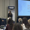 Conference presentation on status game with speaker and audience at AED event