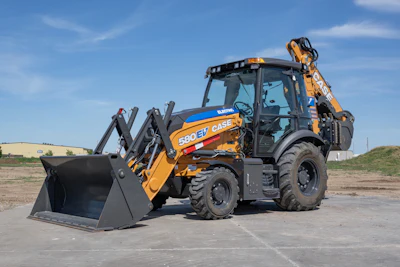 Yellow Case 580 EV backhoe loader on concrete with blue sky background