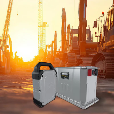 Industrial lithium batteries with construction equipment at sunset