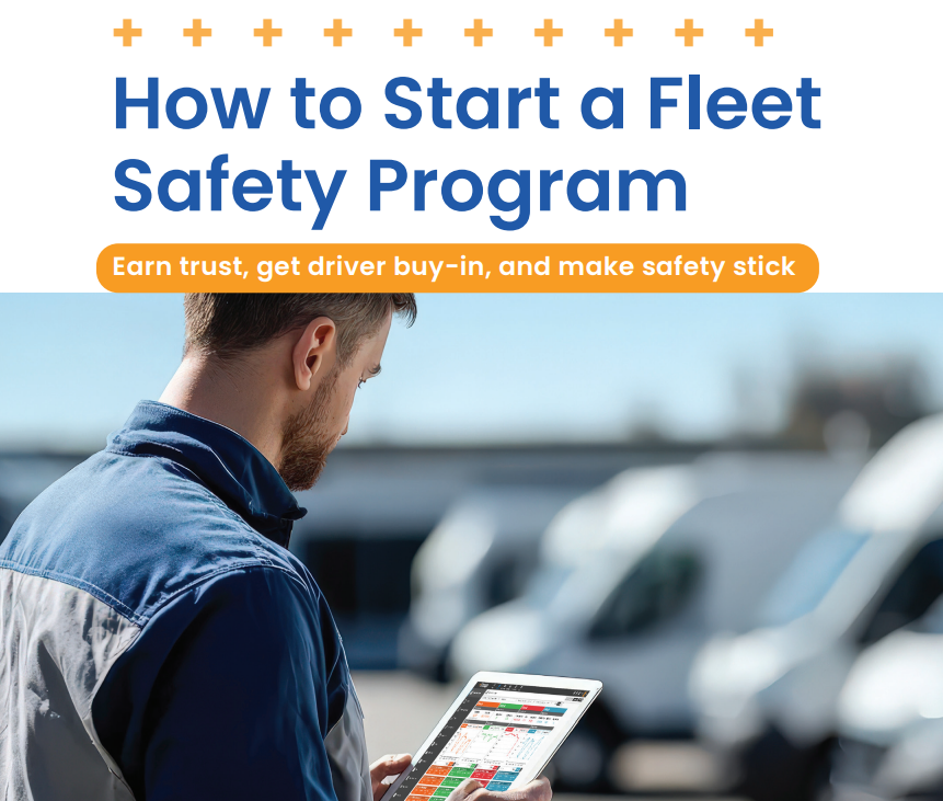 Fleet manager reviewing safety dashboard on tablet in vehicle parking lot