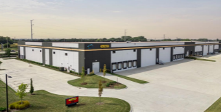 Modern industrial warehouse facility with multiple loading docks and landscaped entrance