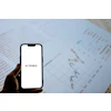 Terex corporate logo displayed on smartphone screen over business documents