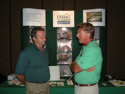 House Guard trade show booth with product display and two representatives