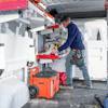Technician working inside a service van with specialized equipment and orange toolbox