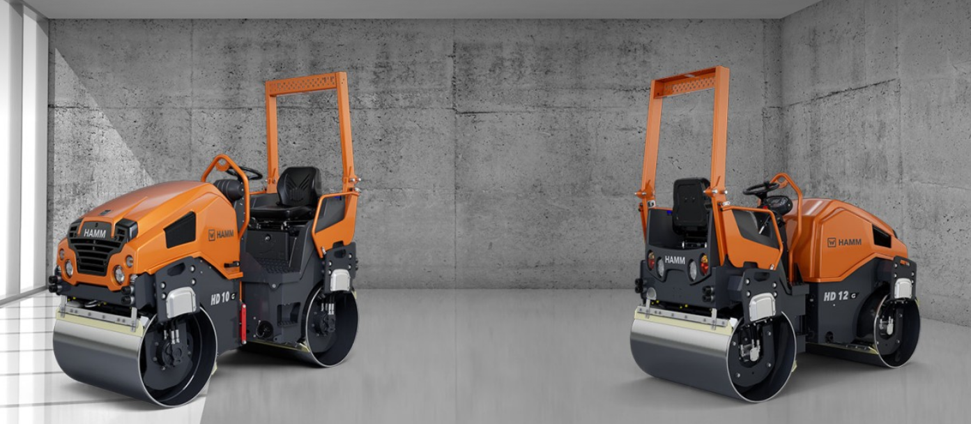 Orange road compactor roller machine in concrete industrial setting