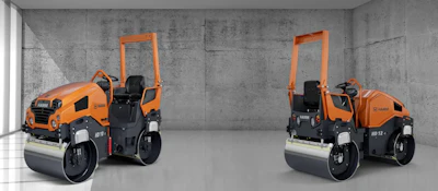 Orange road compactor roller machine in concrete industrial setting