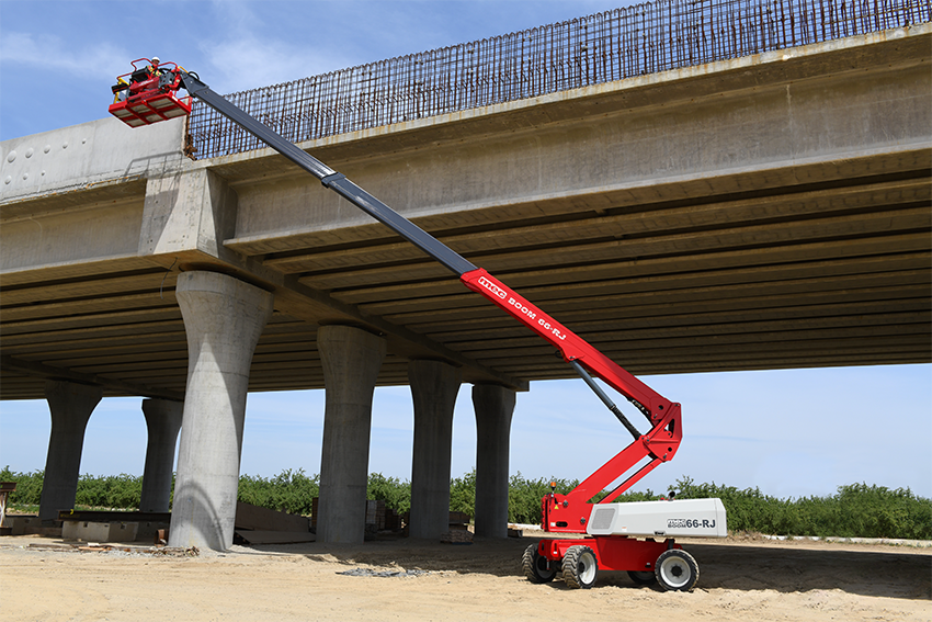Red telescoping boom lift positioned beneath concrete bridge support columns