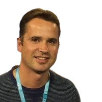Professional headshot of a smiling person wearing a striped shirt and teal lanyard Headshot