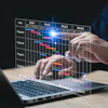 Project management Gantt chart displayed holographically over laptop keyboard