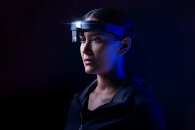 Person wearing high-tech headset against dark blue background