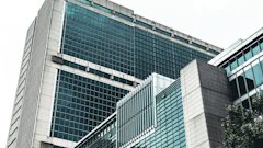 Modern glass and concrete office building with geometric architectural design