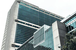 Modern glass and concrete office building with geometric architectural design