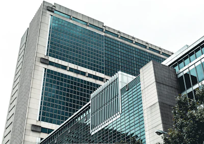 Modern glass and concrete office building with geometric architectural design