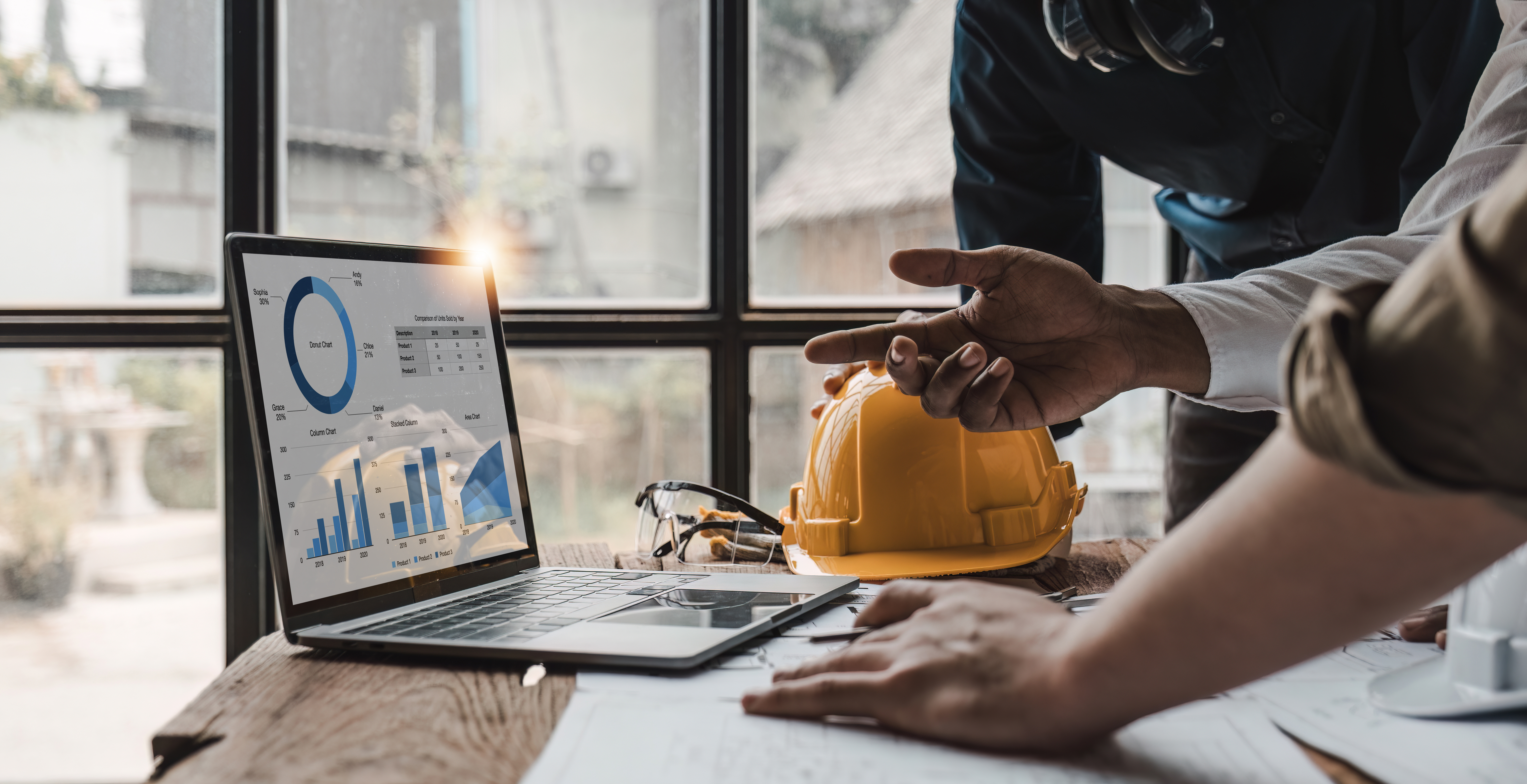 Business analyst reviewing data charts and construction project metrics