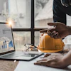 Business analyst reviewing data charts and construction project metrics