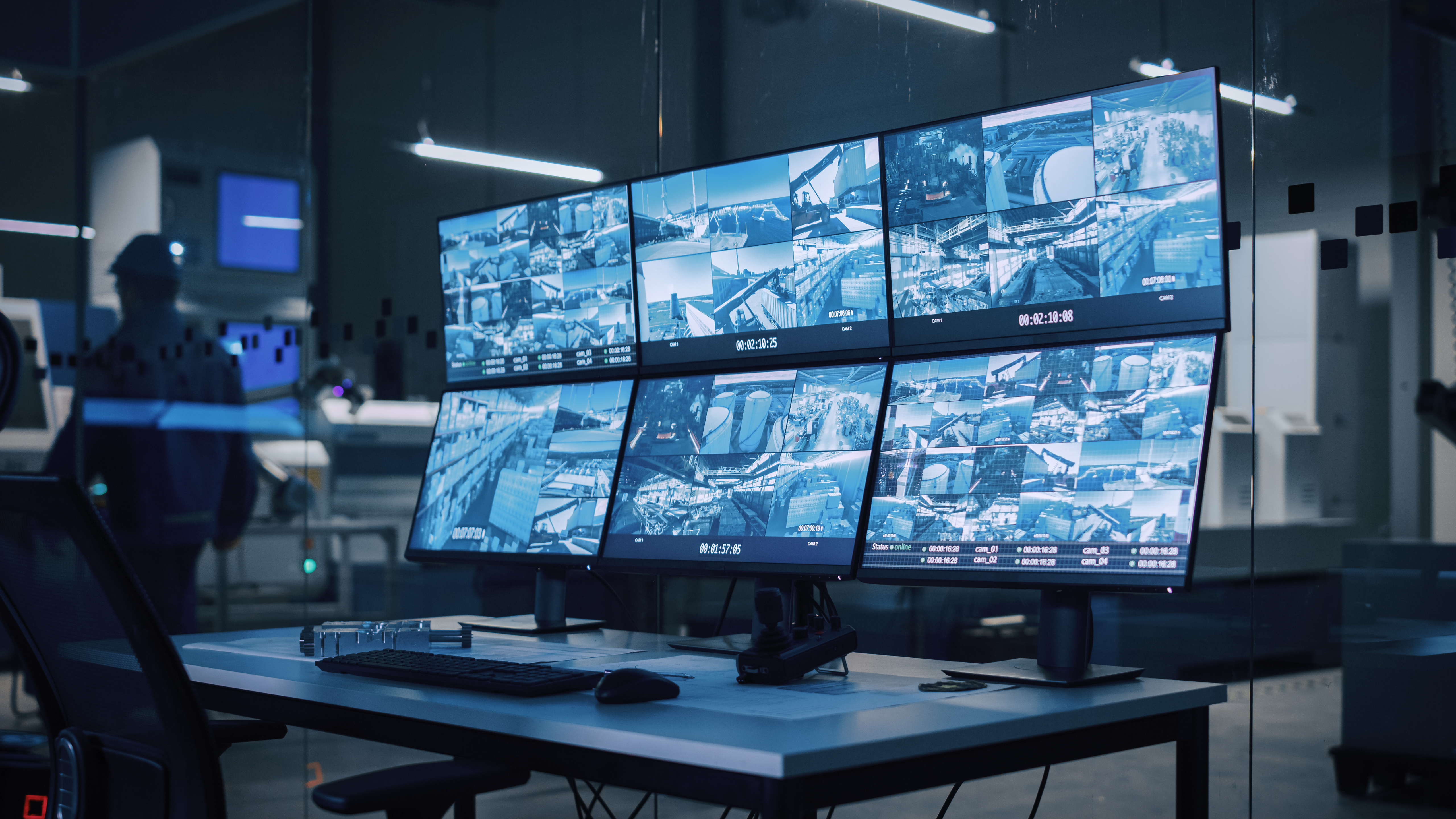 Security control room with multiple monitors displaying surveillance camera feeds