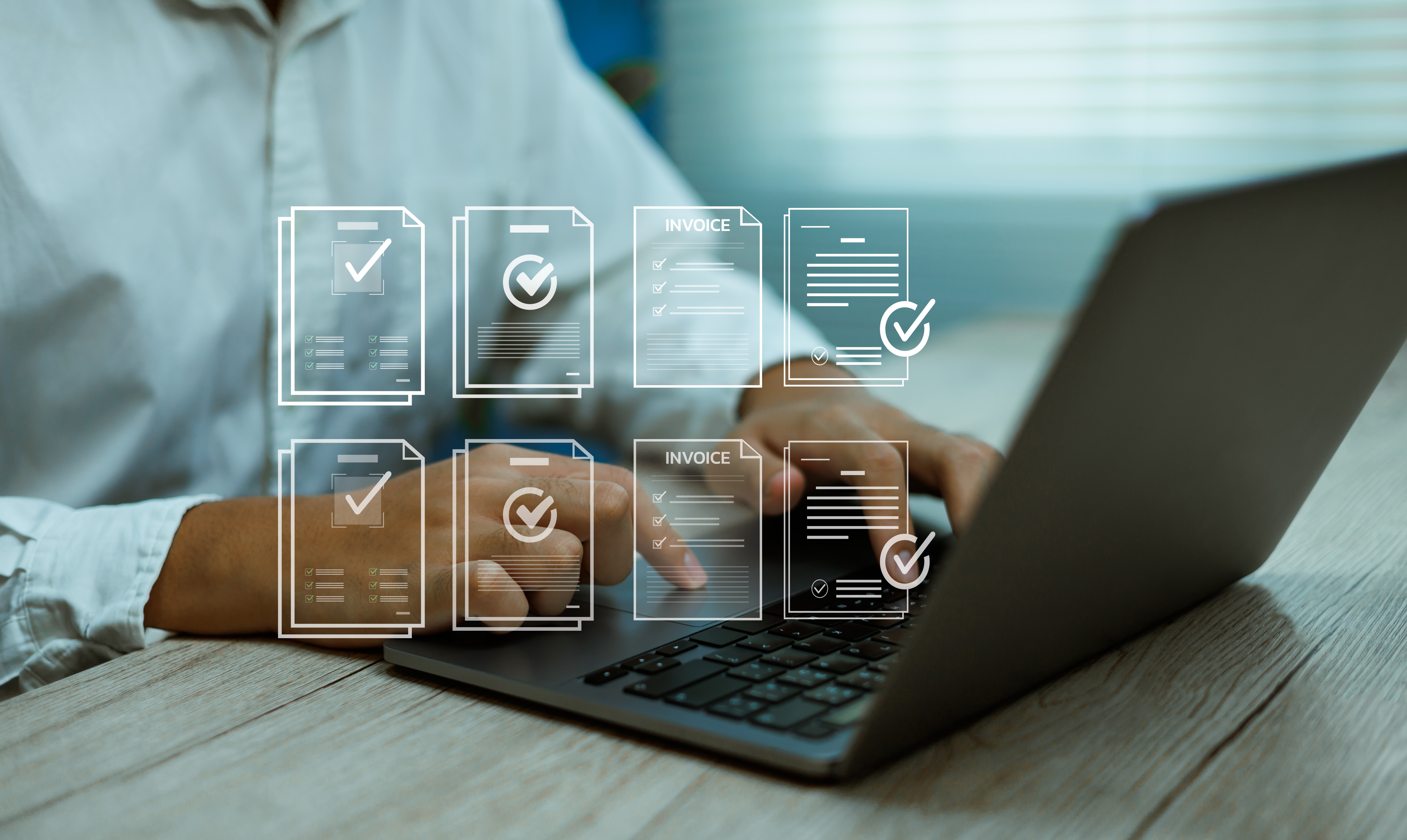 Professional working on laptop with digital invoice and document management icons