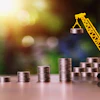 Yellow construction crane lifting coin stack, symbolizing financial growth and investment