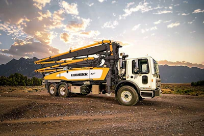Liebherr concrete pump truck at sunset with mountain landscape