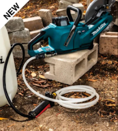 Blue Makita power tool on concrete blocks with white hose and construction debris