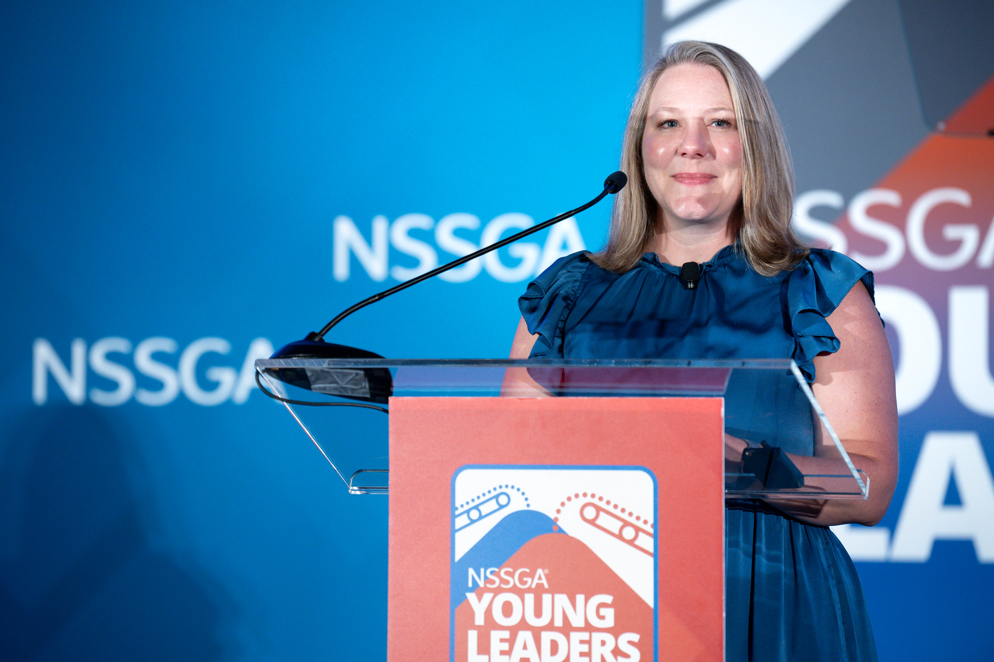 Woman speaking at NSSGA Young Leaders conference podium