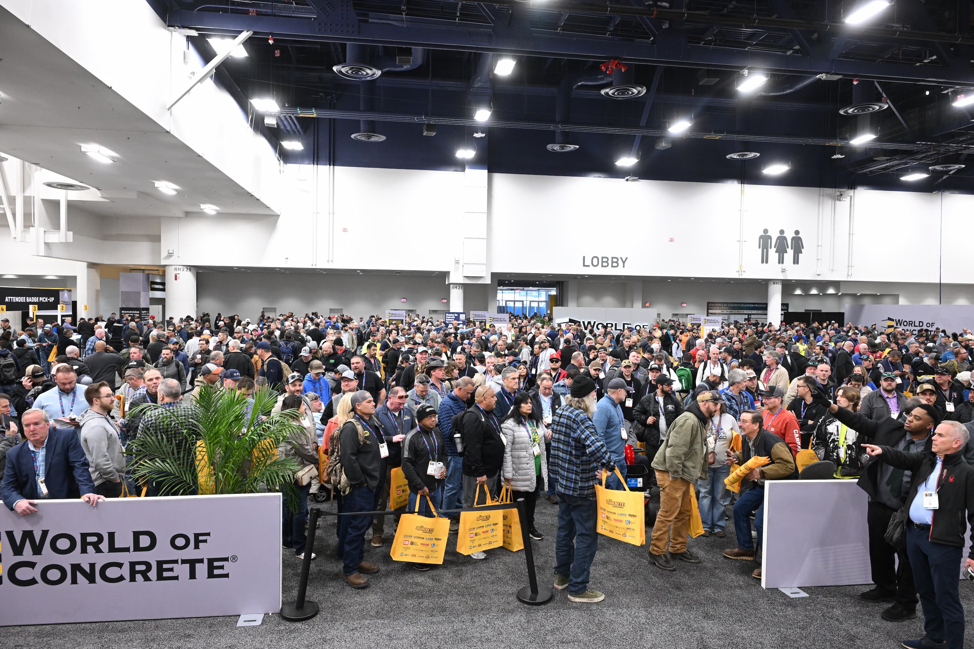 Crowded convention lobby at World of Concrete trade show with attendees