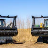 Two tracked Diamond Mowers mulching machines in grassy field