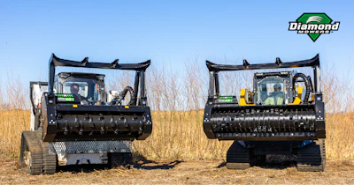 Two tracked Diamond Mowers mulching machines in grassy field
