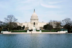 U.S. Capitol building in Washington D.C. with reflecting pool and winter trees