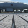 Industrial tanker truck on concrete surface with frost or moisture