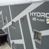 Gray industrial building with Hydro MS Plant logo and security camera