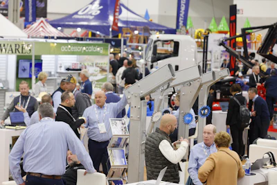 Trade show floor with exhibitors, displays, and technical equipment