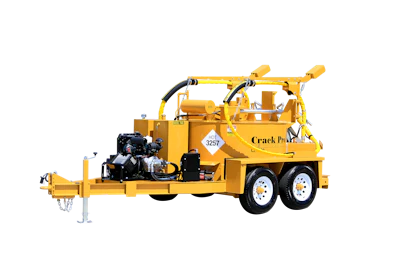 Yellow two-wheel crack sealing trailer with hydraulic equipment