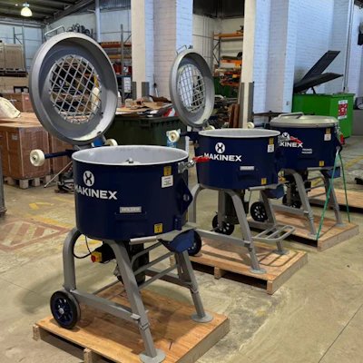 Three navy blue Makinex industrial mixing or construction machines on wooden pallets