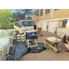 Construction site with Makinex equipment, truck, and building materials