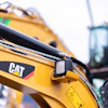 Yellow Caterpillar construction excavator with hydraulic arm and CAT logo