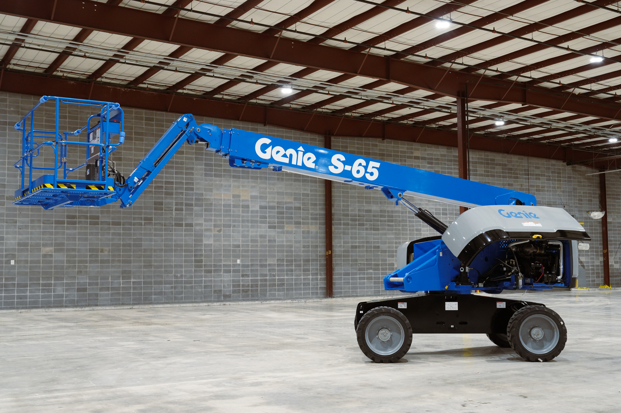 Blue Genie S-65 aerial work platform in industrial warehouse setting