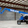 Blue Genie S-65 aerial work platform in industrial warehouse setting