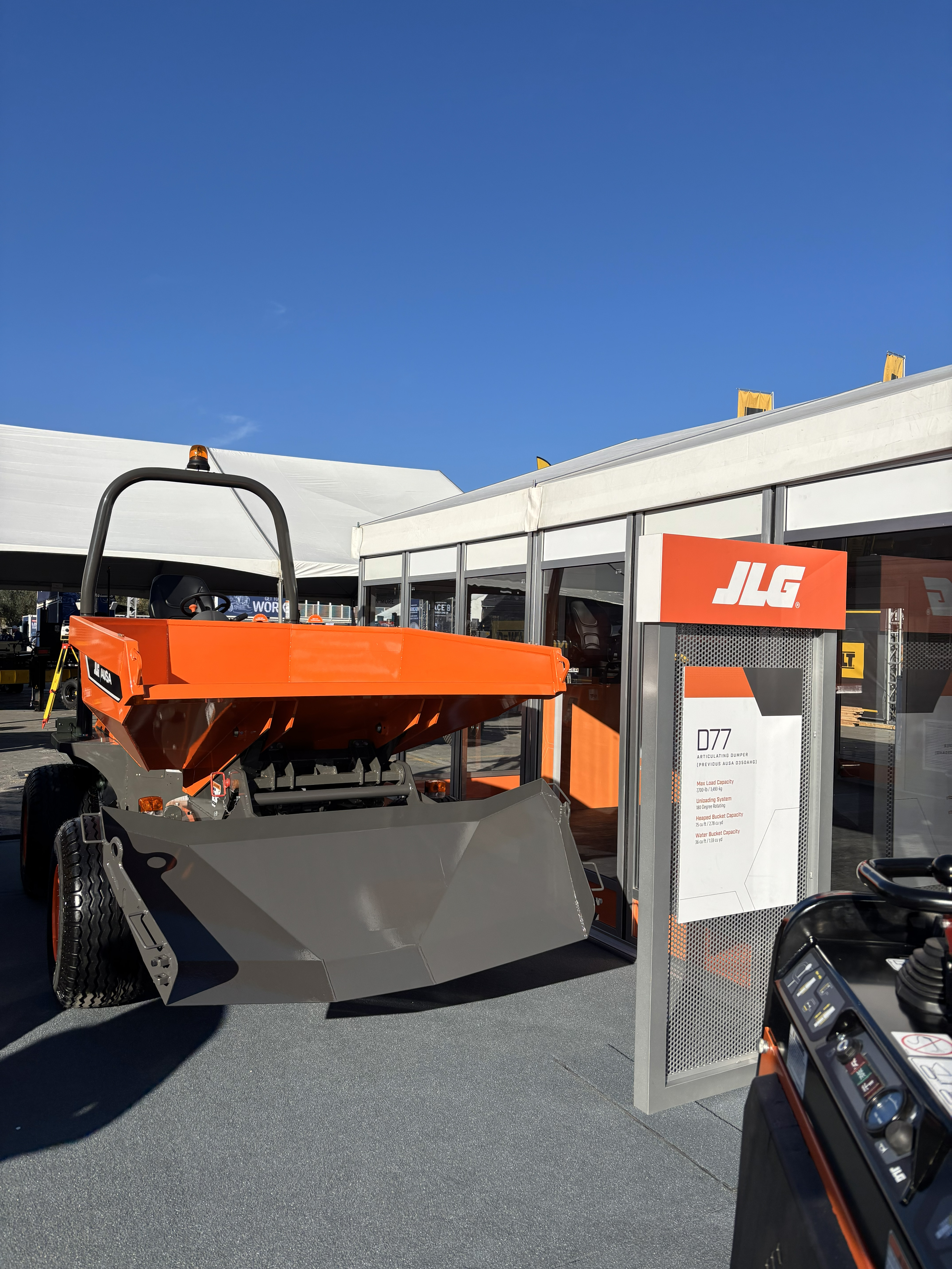 Orange JLG industrial machine on display at an outdoor exhibit