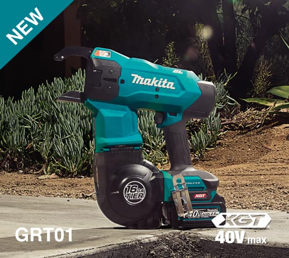 Makita 40V cordless power tool on concrete with battery, surrounded by plants