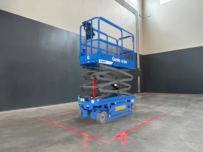 Blue Genie scissor lift platform elevated in warehouse with red safety outline on concrete floor