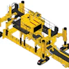 Yellow industrial robotic machinery with multiple hydraulic pistons and conveyor system