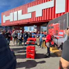 Hilti product demonstration with red tool cases at outdoor trade event