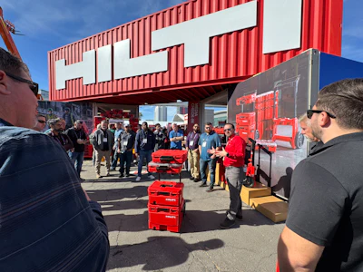 Hilti product demonstration with red tool cases at outdoor trade event