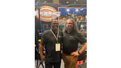 Two professionals at PLS Portable Lighting Solutions trade show booth