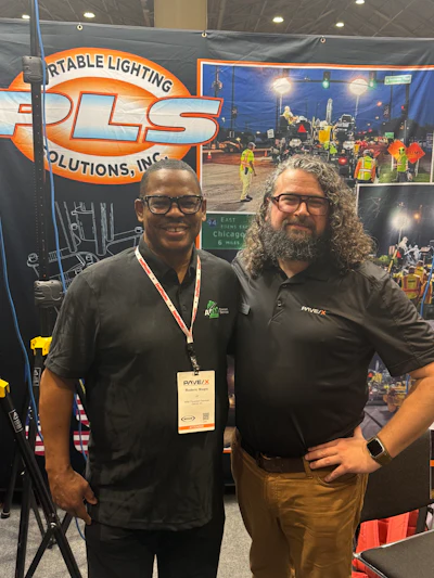 Two professionals at PLS Portable Lighting Solutions trade show booth
