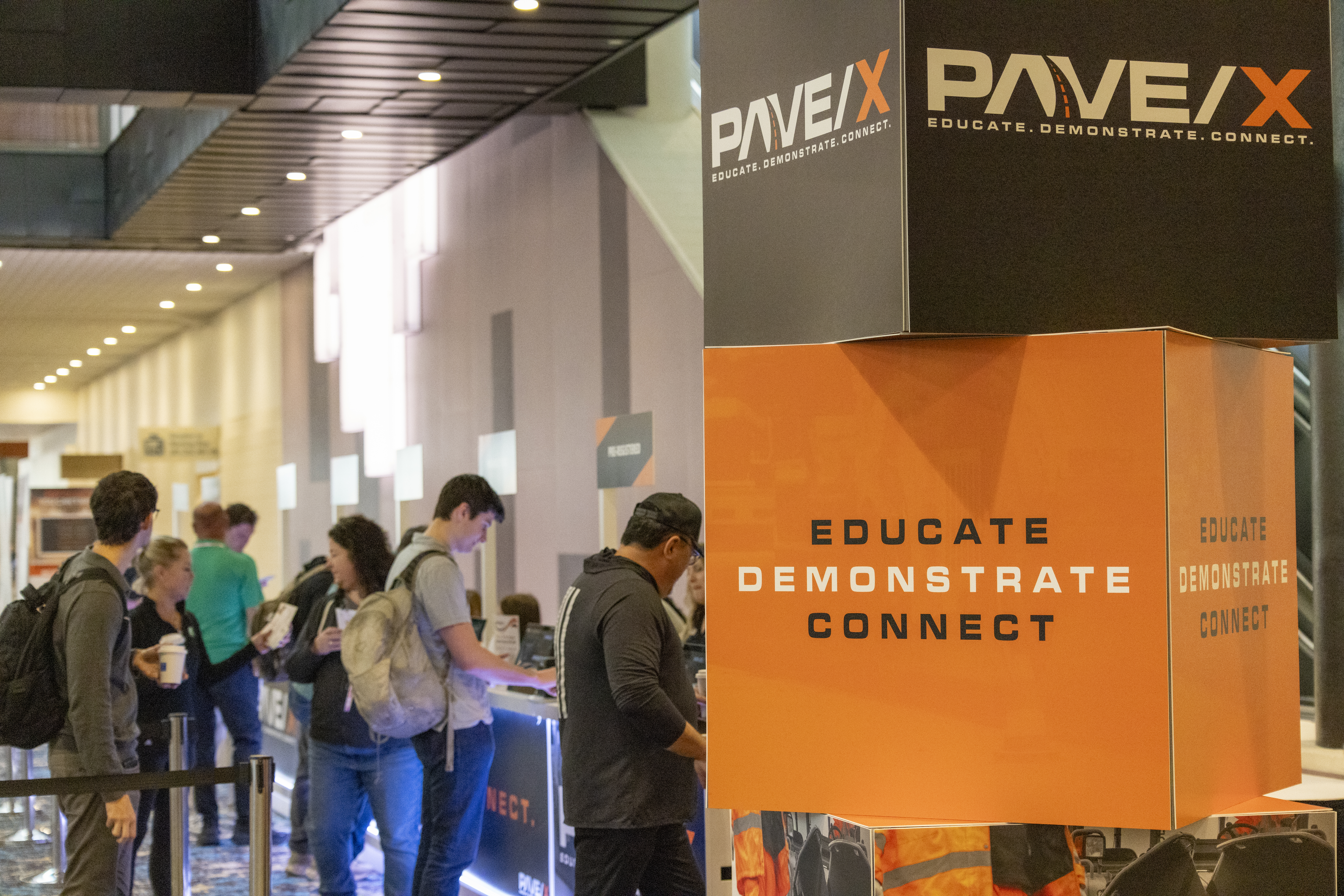 PAVEX conference booth with orange and black branding displays