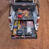 Pickup truck storage drawer with organized tools, work equipment, and supplies