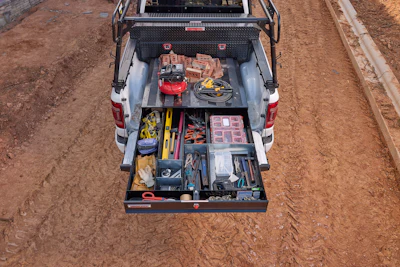 Pickup truck storage drawer with organized tools, work equipment, and supplies