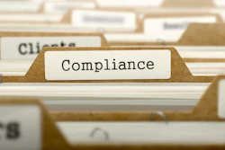 Manilla file folder tab labeled 'Compliance' in a document filing system